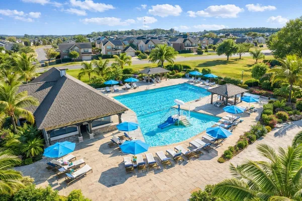 an aerial view of a house with a swimming pool yard and outdoor seating