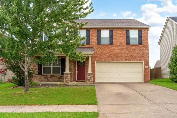 a living room with furniture kitchen view and a large window
