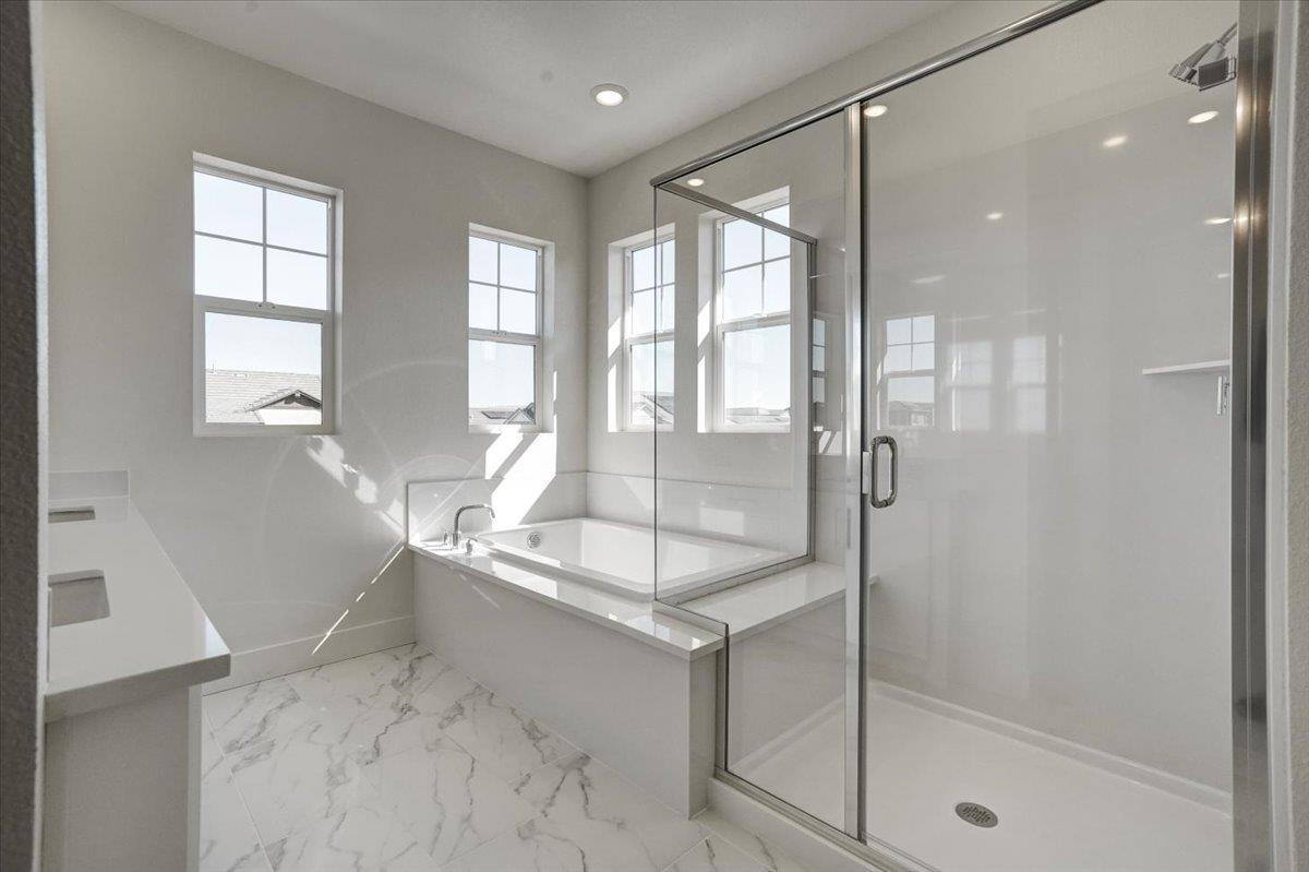 12101 Almeria Way San Ramon, CA 94583 - Photo 27 of 44 a bathroom with a granite countertop sink a mirror and a shower