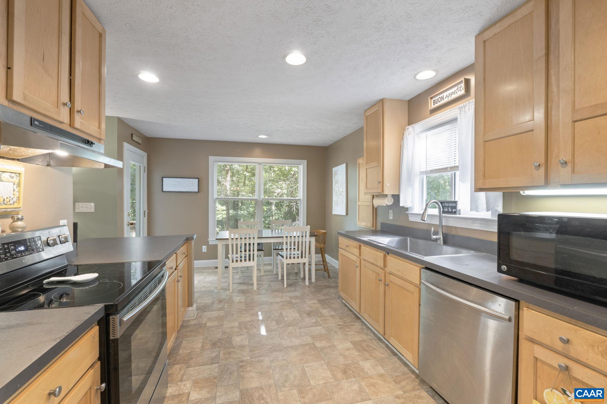4 Clark Court Palmyra, VA 22963 - Photo 11 of 58 a large kitchen with kitchen island a sink a counter top space and stainless steel appliances