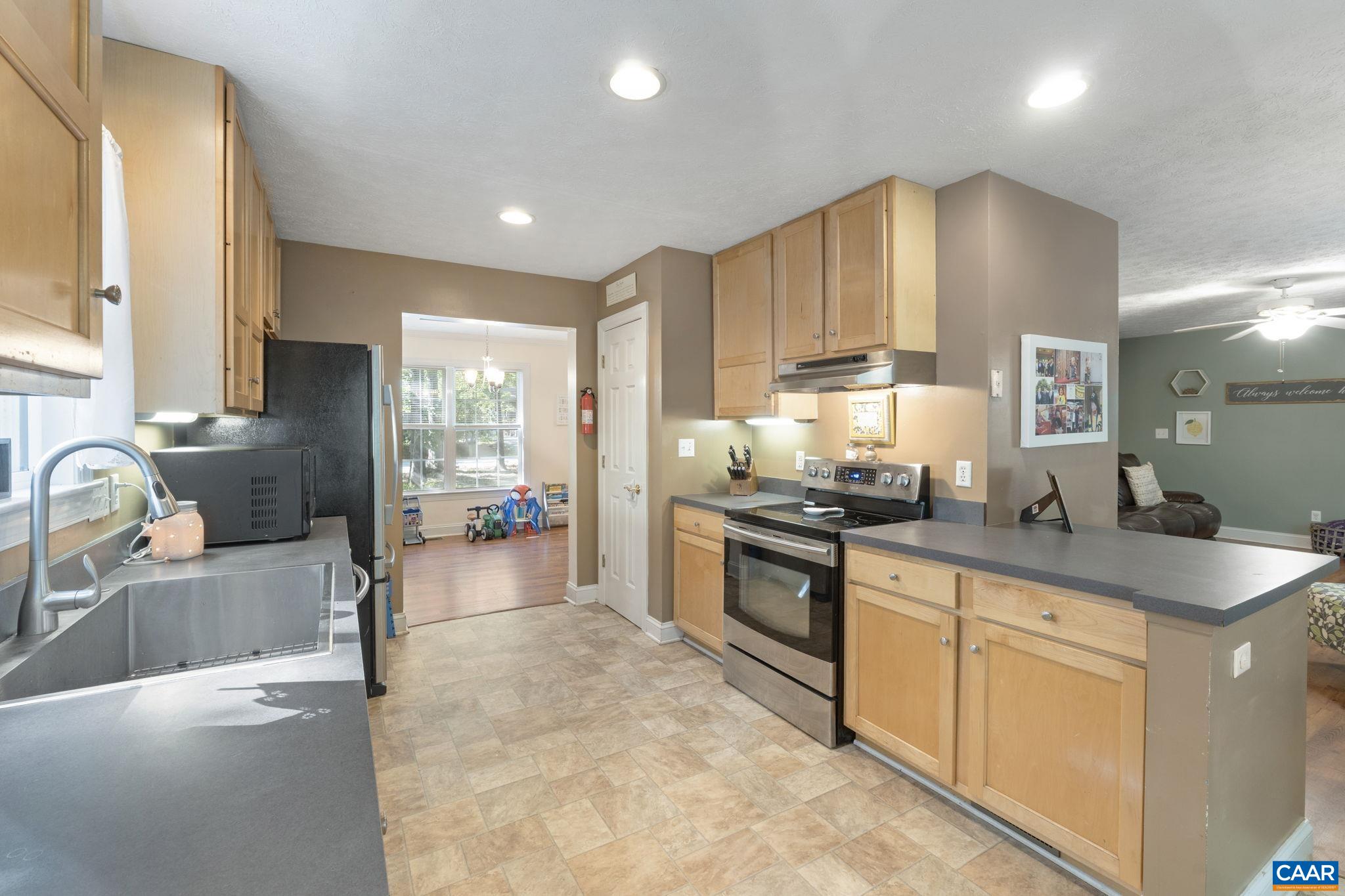 4 Clark Court Palmyra, VA 22963 - Photo 12 of 58 a kitchen with stainless steel appliances granite countertop a sink stove and refrigerator
