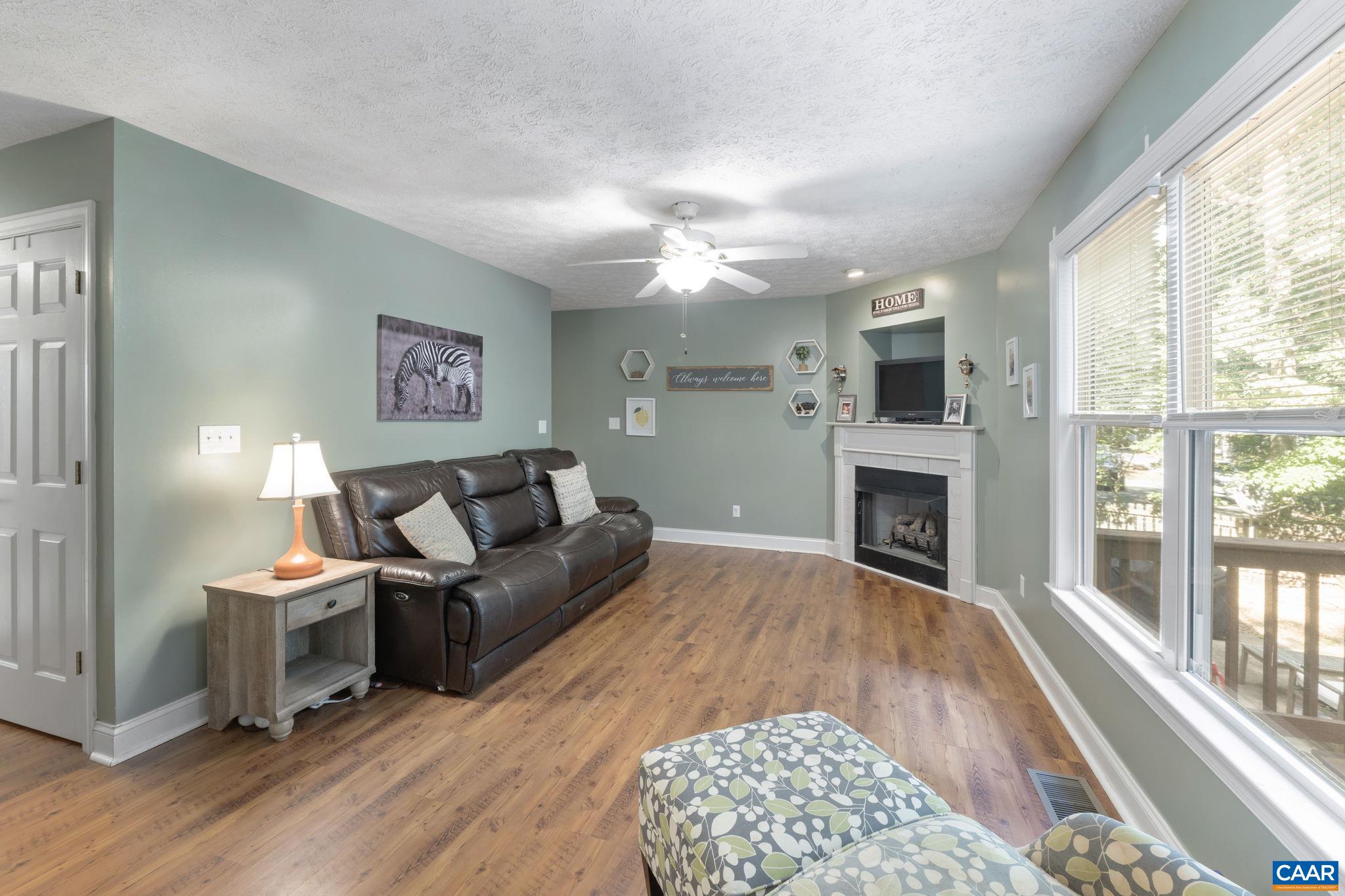 4 Clark Court Palmyra, VA 22963 - Photo 19 of 58 a living room with furniture a fireplace and a large window