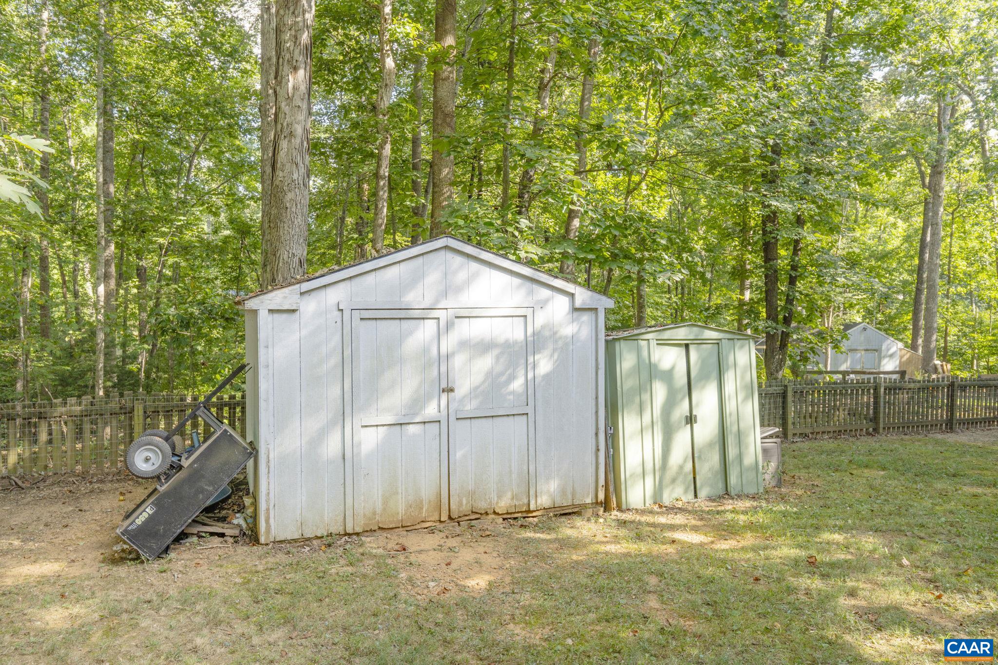 4 Clark Court Palmyra, VA 22963 - Photo 36 of 58 a backyard of a house with large trees and a barn