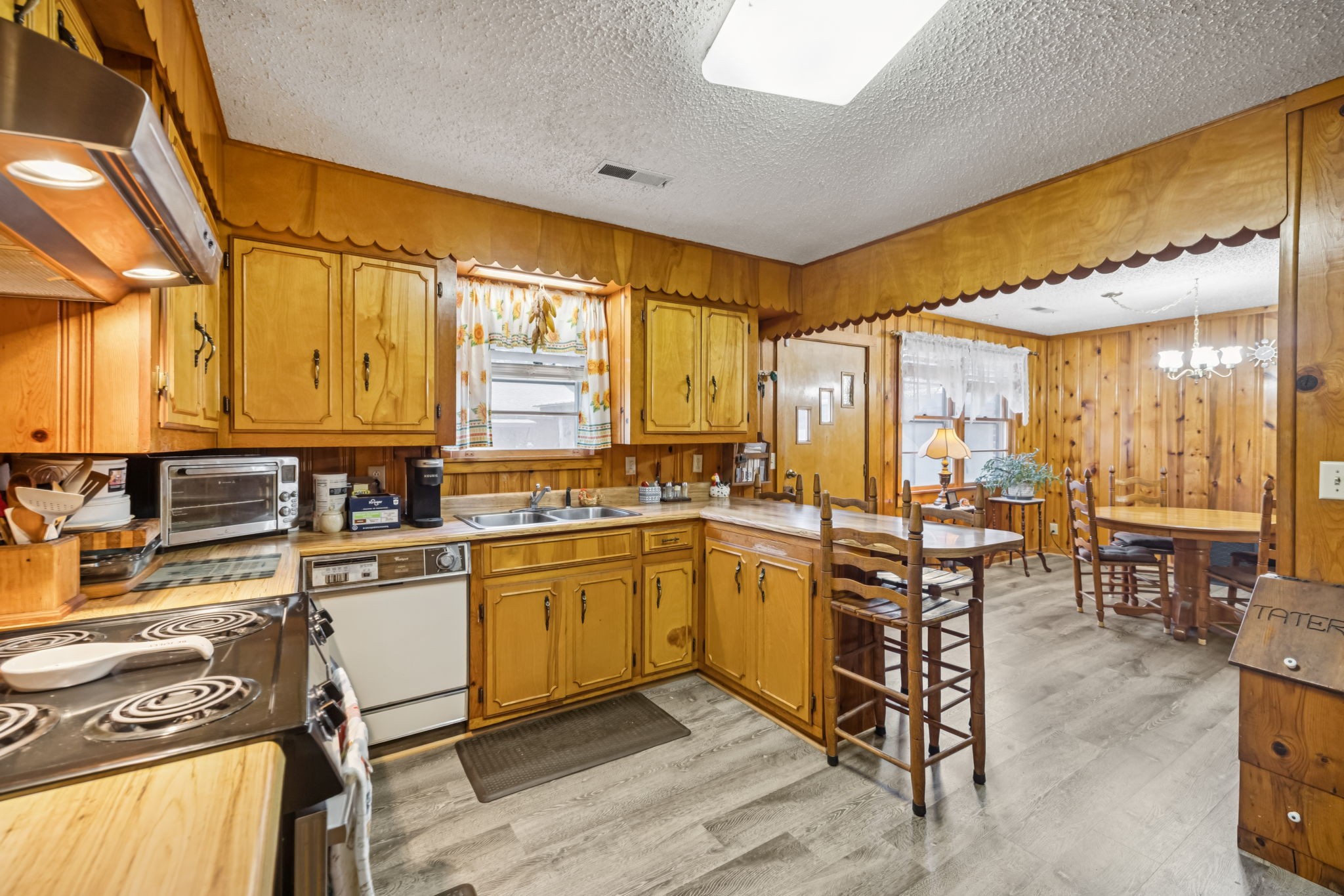 5165 Almaville Road Smyrna, TN 37167 - Photo 20 of 37 a kitchen with stainless steel appliances granite countertop sink stove and white cabinets with wooden floor