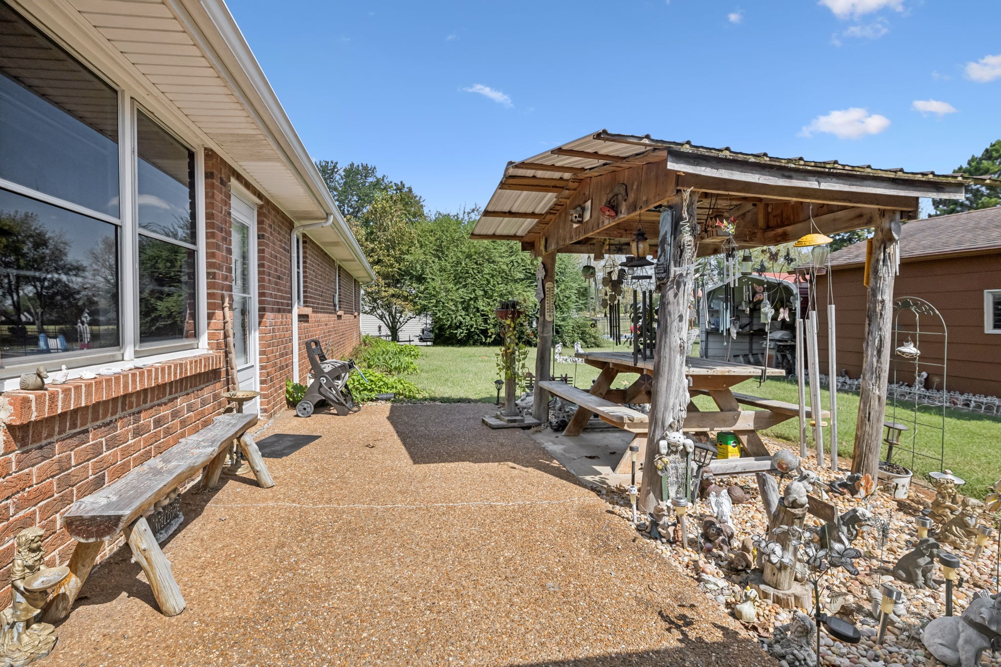 5165 Almaville Road Smyrna, TN 37167 - Photo 4 of 37 a view of a patio with table and chairs under an umbrella with a large tree