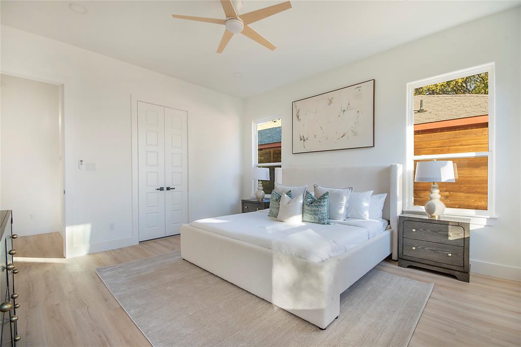 3902 Furey Street Dallas, TX 75212 - Photo 12 of 34 Bedroom featuring light wood-style floors, a ceiling fan, and a closet