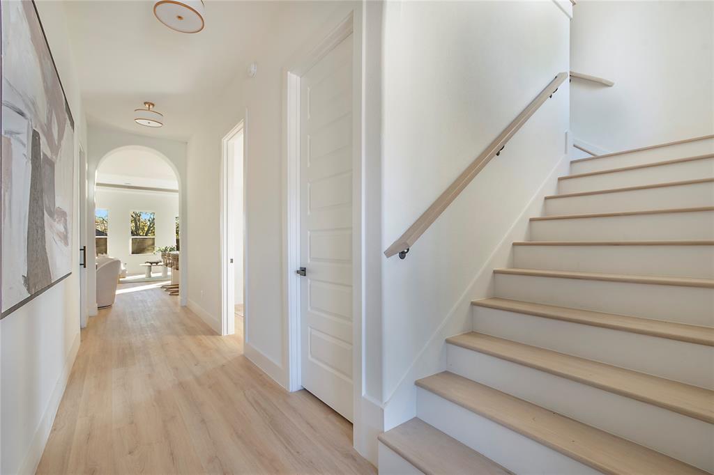 3902 Furey Street Dallas, TX 75212 - Photo 18 of 34 Staircase with wood finished floors and arched walkways
