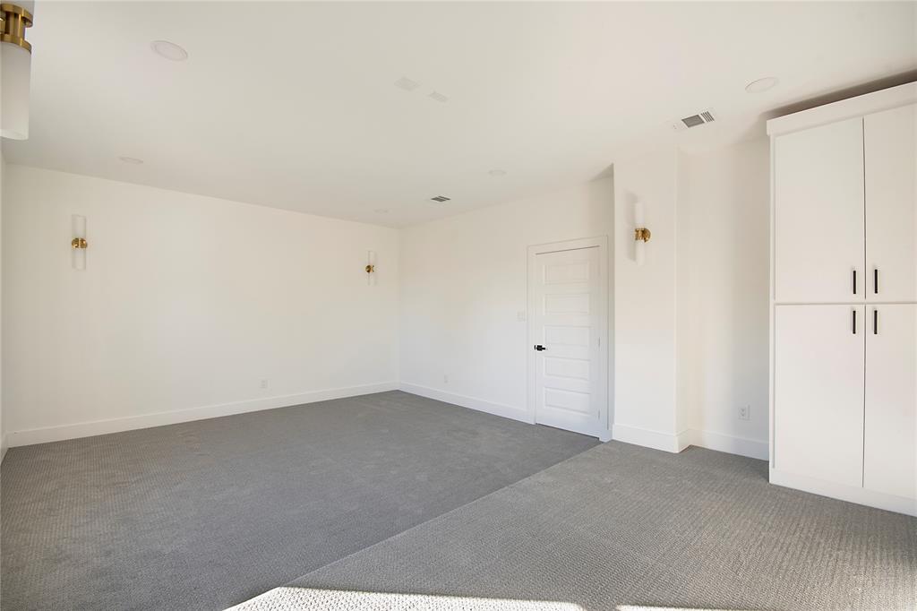 3902 Furey Street Dallas, TX 75212 - Photo 30 of 34 Unfurnished bedroom featuring dark colored carpet and baseboards