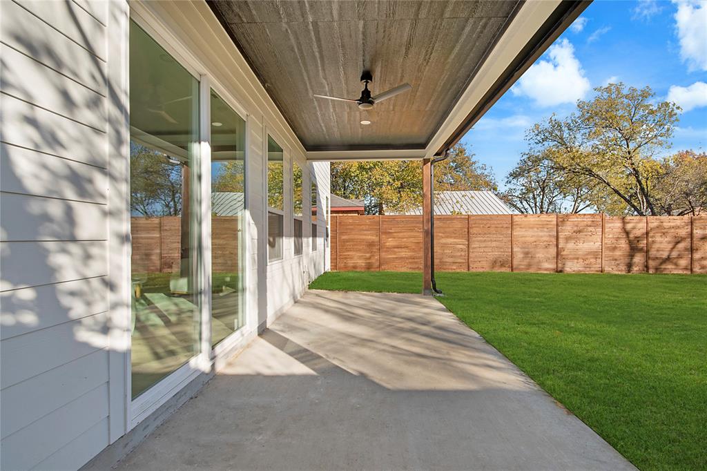 3902 Furey Street Dallas, TX 75212 - Photo 33 of 34 Fenced backyard featuring a ceiling fan and a patio