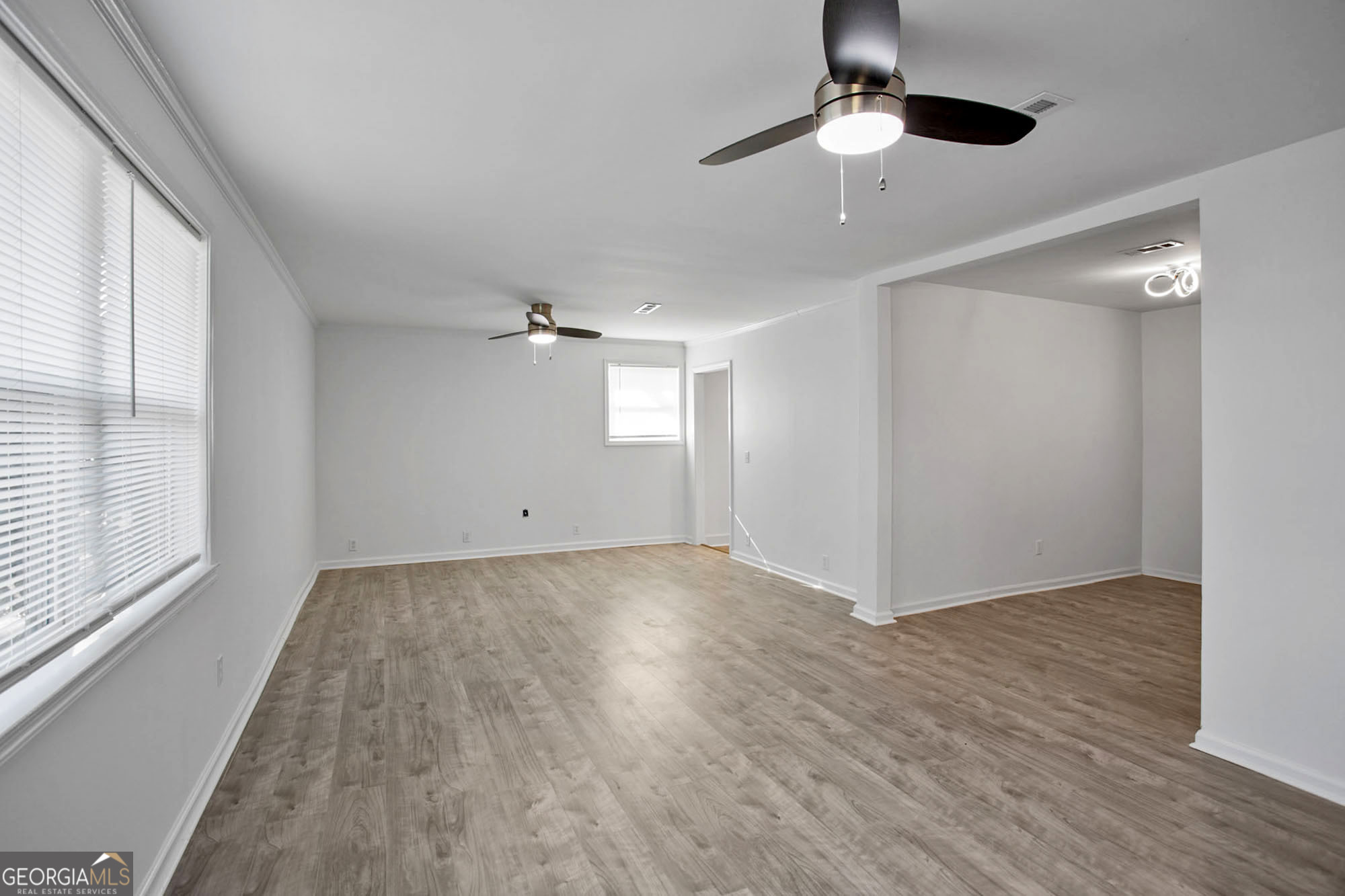 3 Cottonhill Road Eufaula, AL 36027 - Photo 11 of 16 an empty room with wooden floor chandelier fan and windows