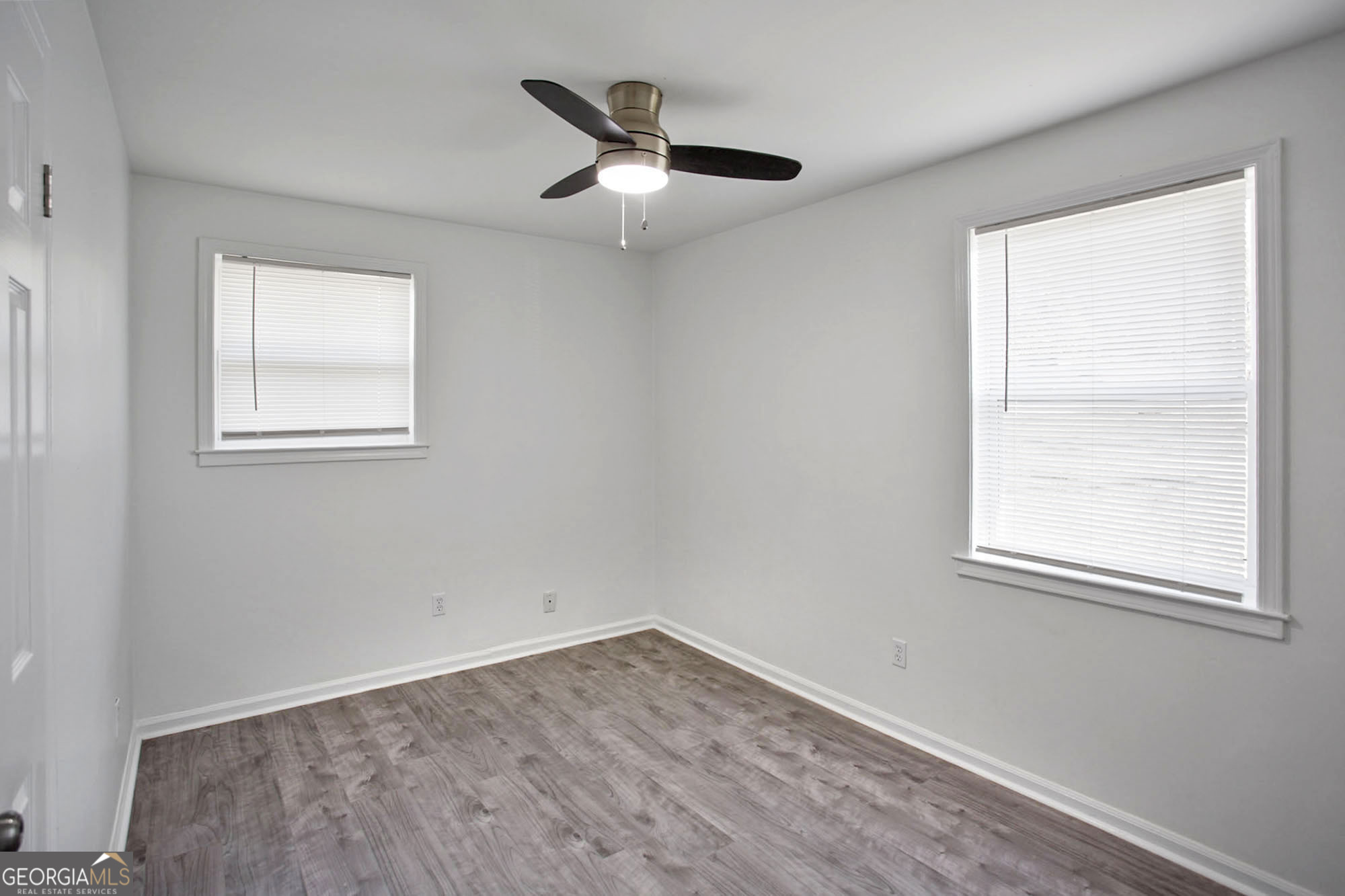 3 Cottonhill Road Eufaula, AL 36027 - Photo 14 of 16 an empty room with wooden floor ceiling fan and windows