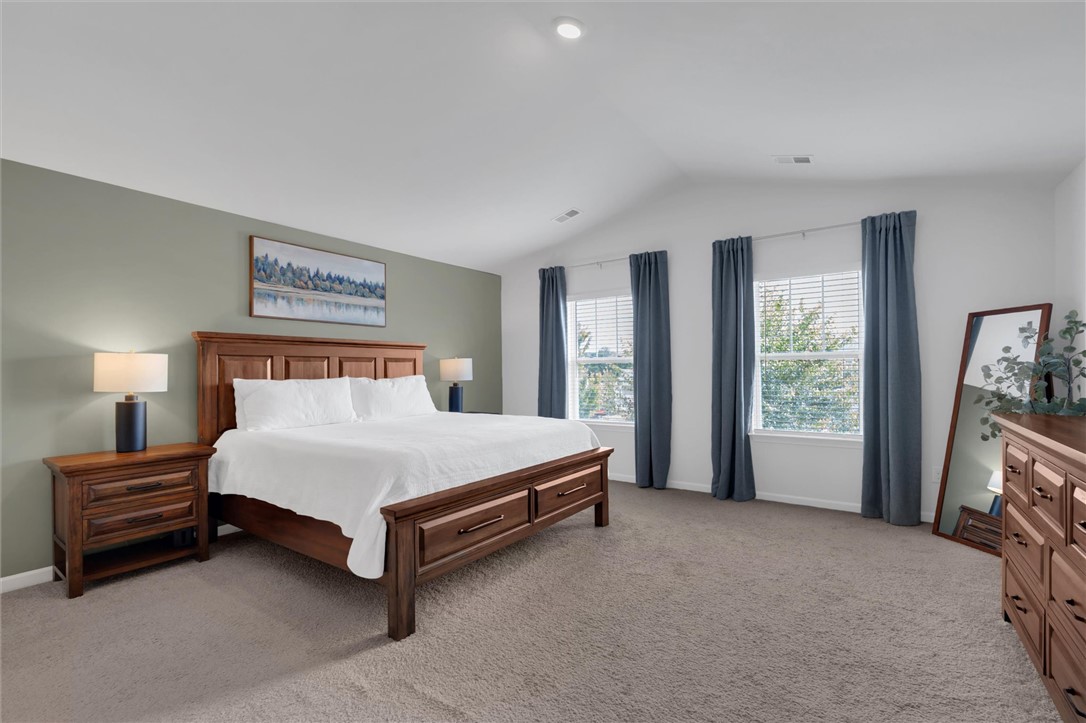 34 Karkinnen Court Pendleton, SC 29670 - Photo 18 of 36 A spacious sleeping area with vaulted ceilings and ample natural light from multiple windows.