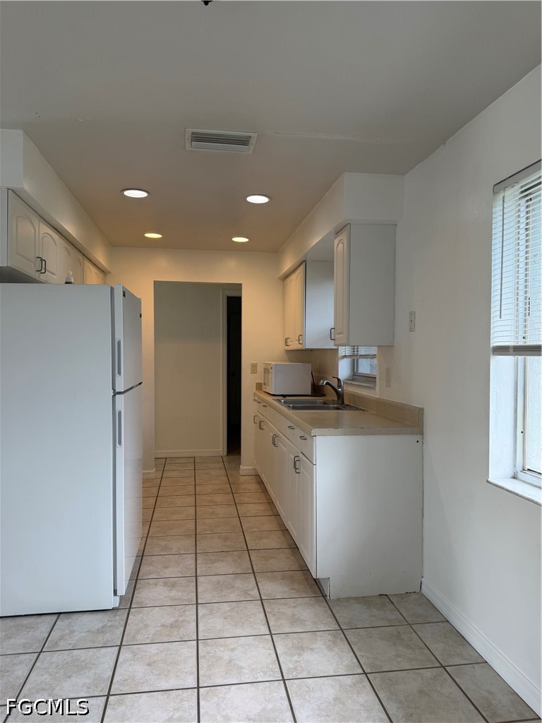 2610 W Road Fort Myers, FL 33905 - Photo 8 of 23 a large white kitchen with a sink and dishwasher a refrigerator with wooden floor