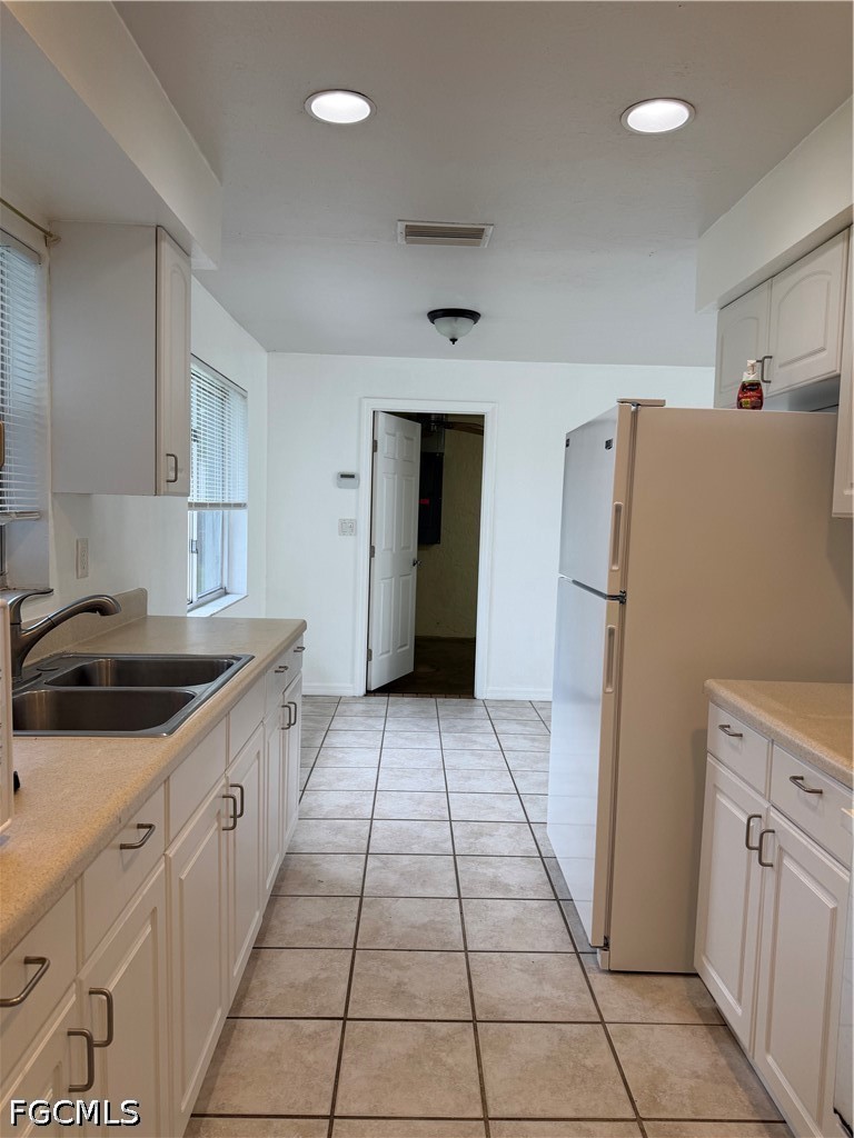 2610 W Road Fort Myers, FL 33905 - Photo 10 of 23 a kitchen with a sink a refrigerator and a stove top oven