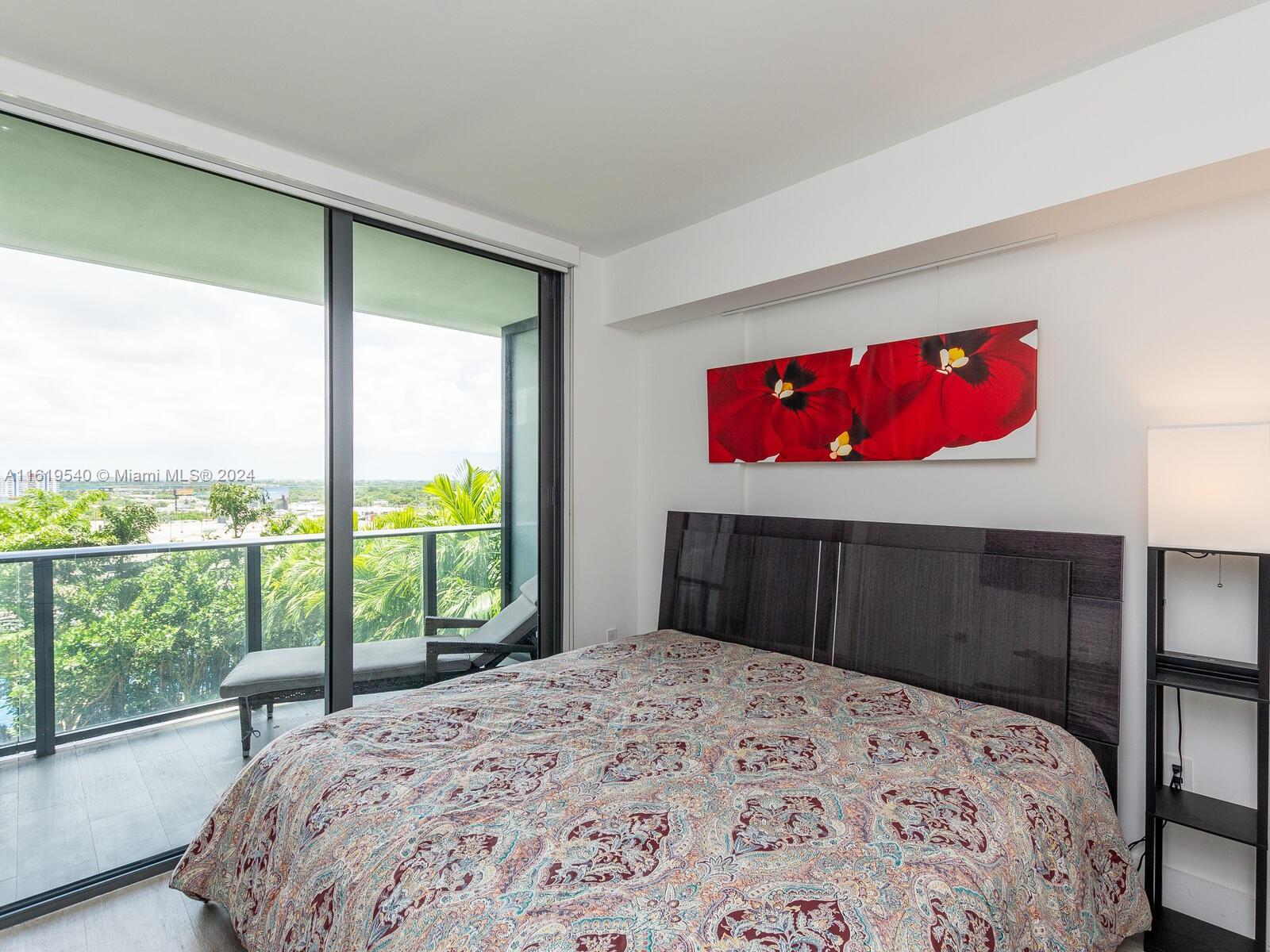 121 Northeast 34th Street, Unit 1014 Miami, FL 33137 - Photo 12 of 30 a bedroom with a bed and a large window