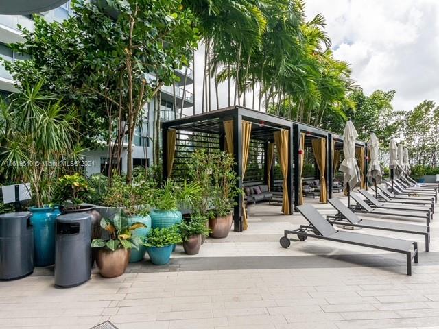 121 Northeast 34th Street, Unit 1014 Miami, FL 33137 - Photo 29 of 30 a view of a patio with couches and a potted plant