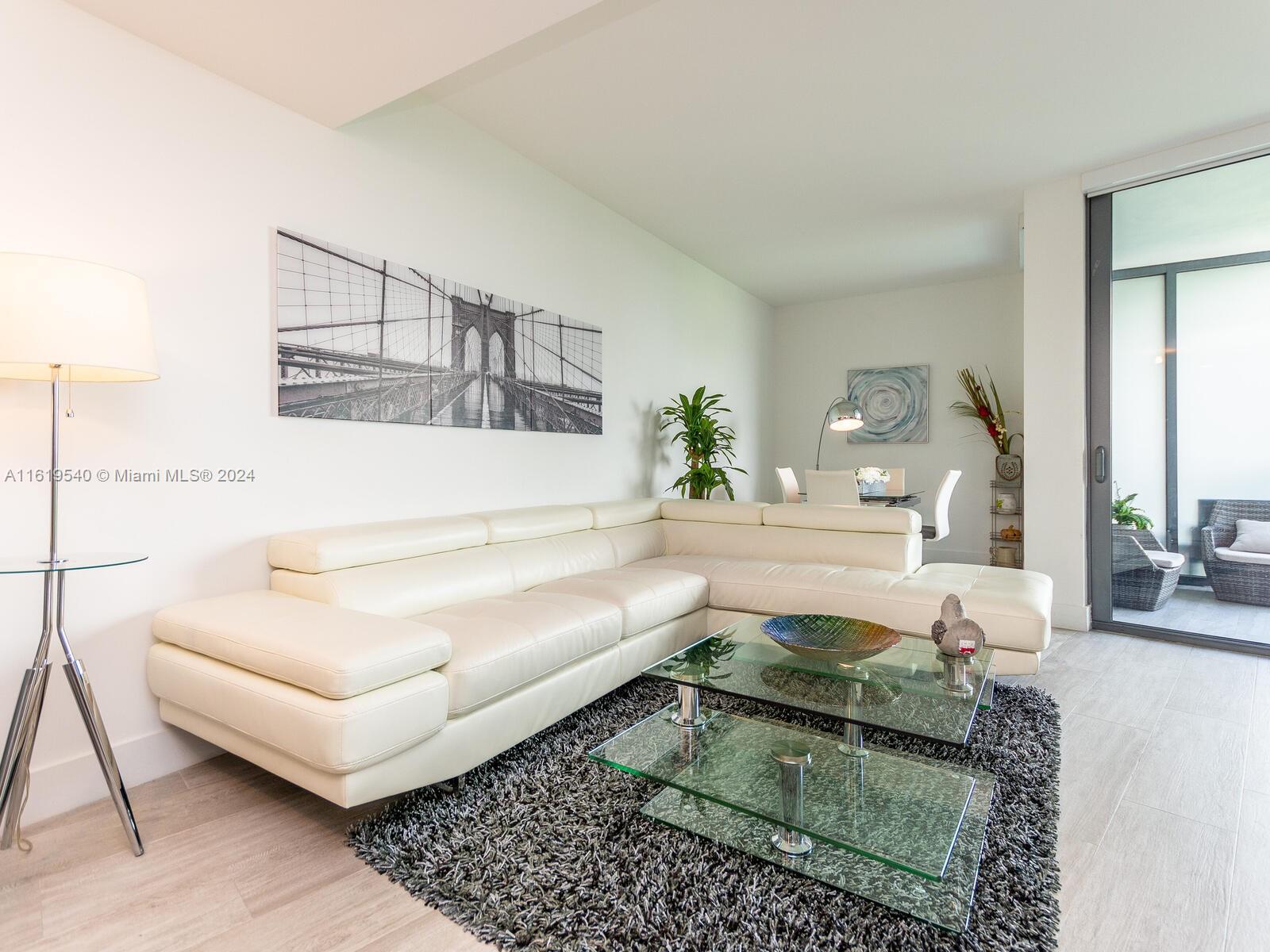 121 Northeast 34th Street, Unit 1014 Miami, FL 33137 - Photo 6 of 30 a living room with furniture and a rug