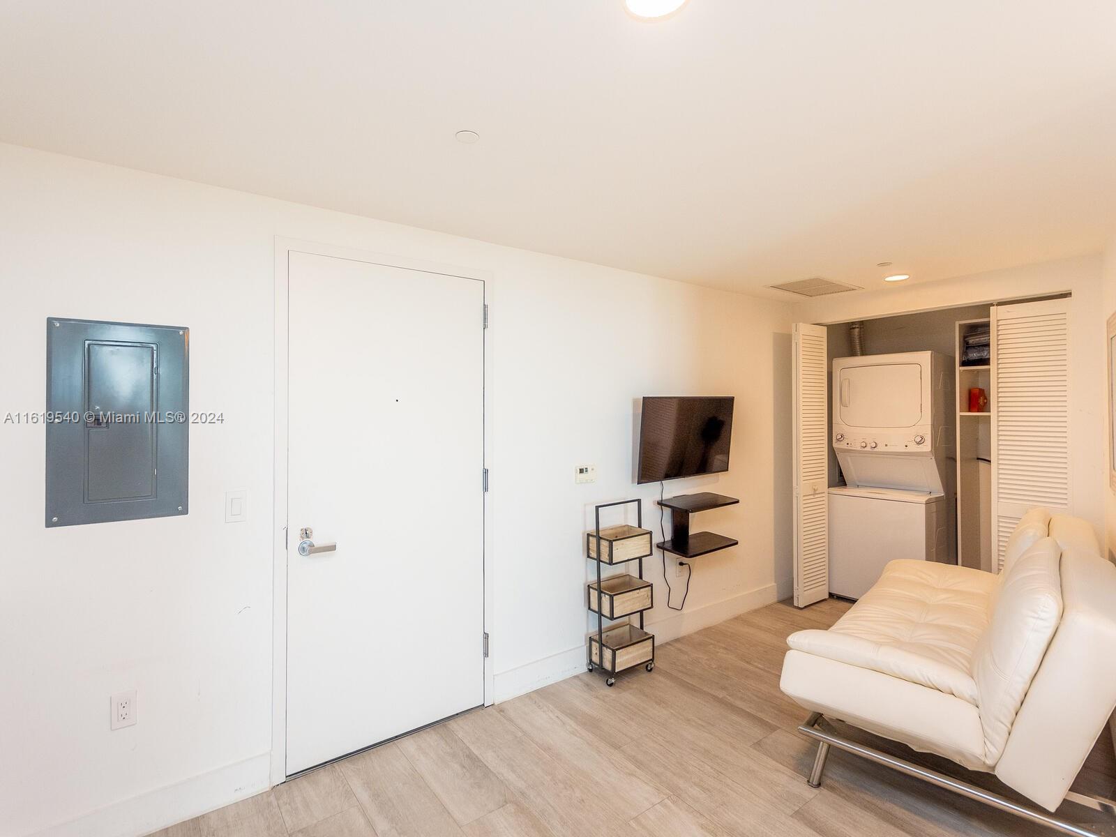 121 Northeast 34th Street, Unit 1014 Miami, FL 33137 - Photo 7 of 30 a living room with furniture and a flat screen tv