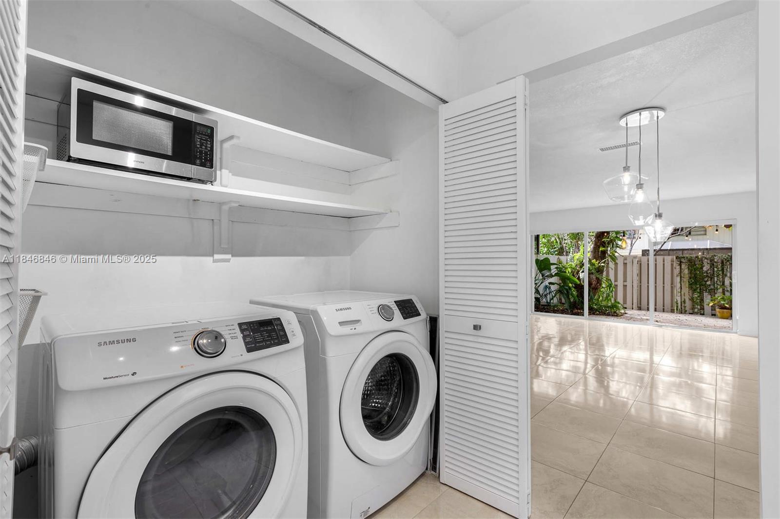 8218 Southwest 82nd Court Miami, FL 33143 - Photo 7 of 20 a view of a hallway with washer and dryer