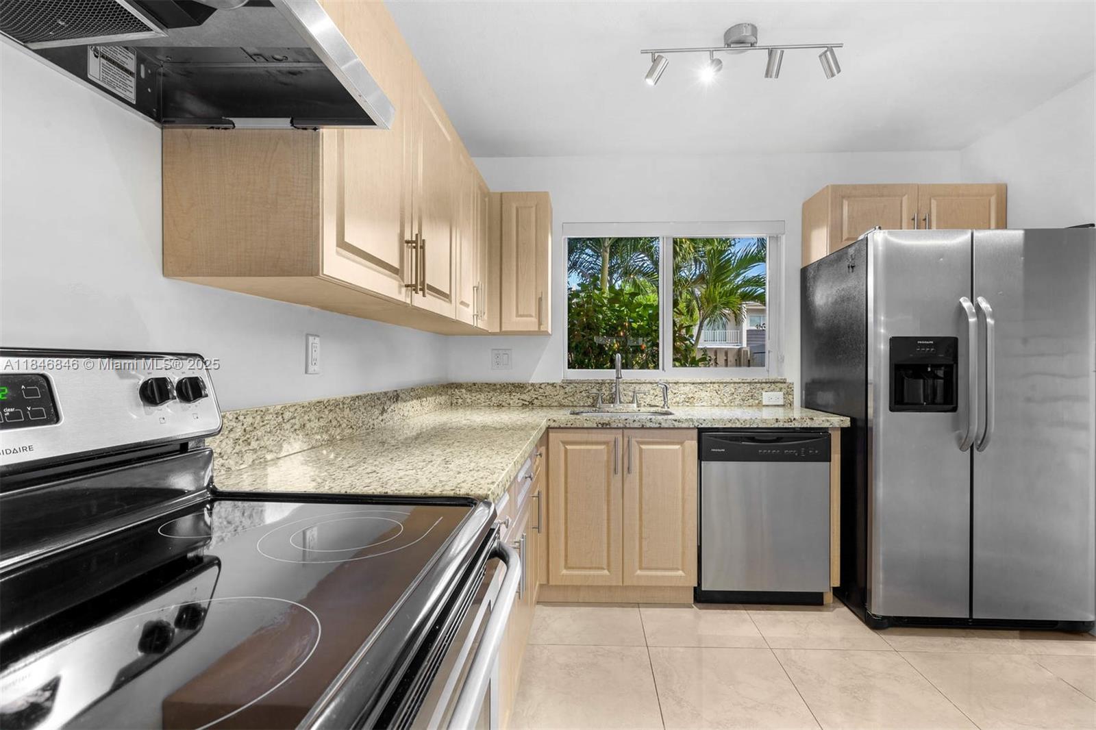 8218 Southwest 82nd Court Miami, FL 33143 - Photo 9 of 20 a kitchen with stainless steel appliances granite countertop a refrigerator and a stove
