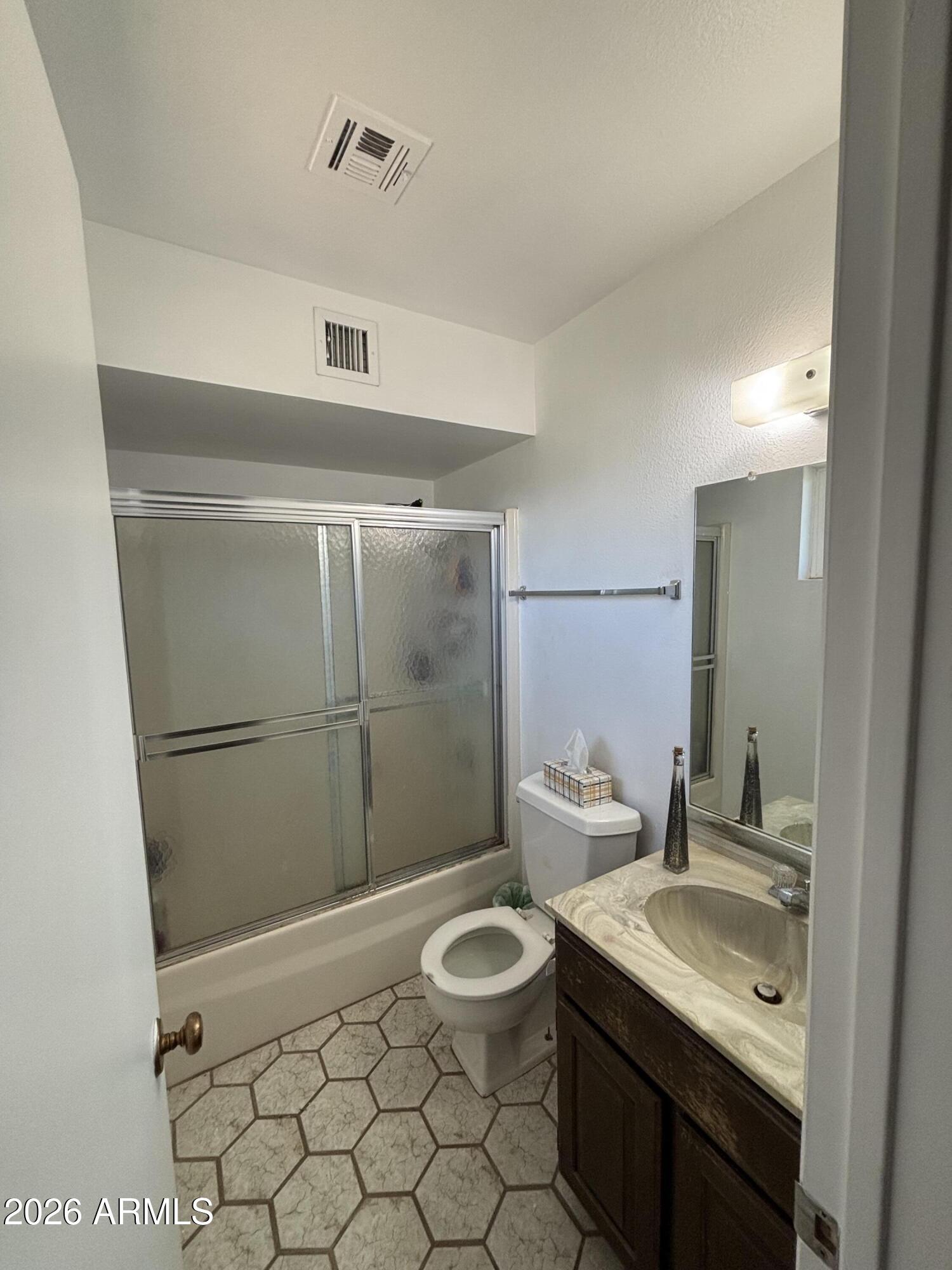 6508 West Fremont Road Laveen, AZ 85339 - Photo 12 of 32 a bathroom with a sink toilet and shower
