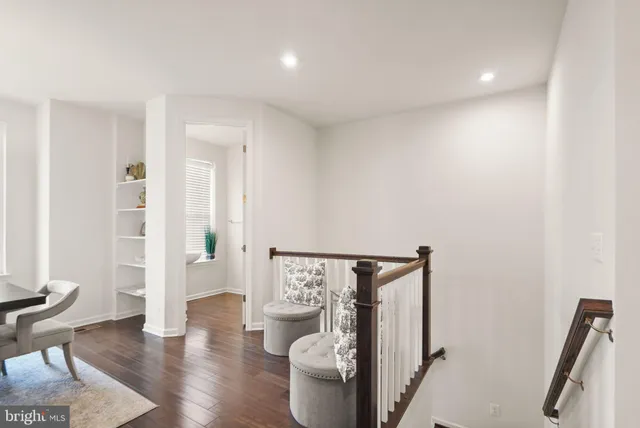 a kitchen with a refrigerator a stove a sink dishwasher with a dining table and chairs