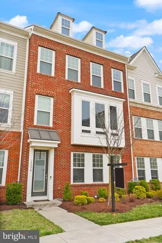 a front view of a building with a yard