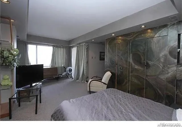 a bedroom with a bed and a desk