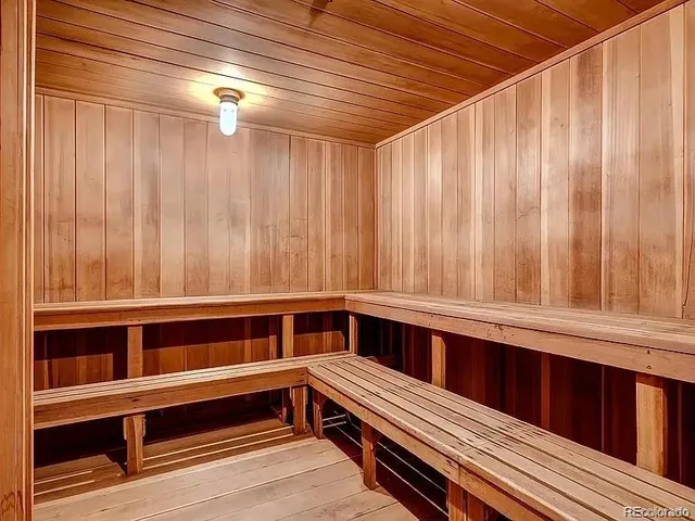 a view of a room with wooden walls and a window