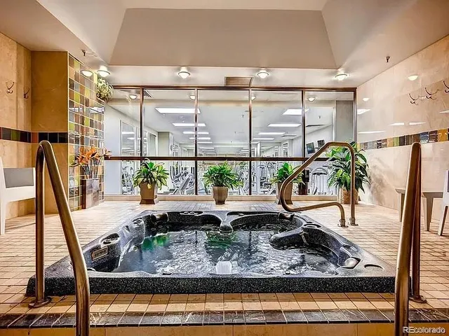 a view of a living room with furniture and a potted plant