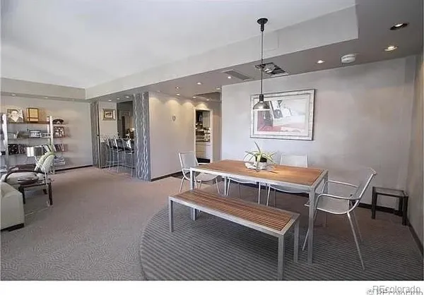 a living room with furniture a desk and chair with wooden floor