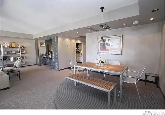 a living room with furniture a desk and chair with wooden floor