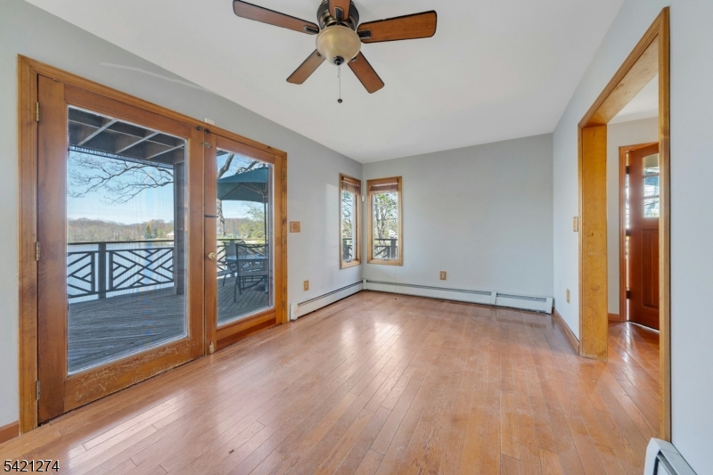95 Wildwood Road Oak Ridge, NJ 07438 - Photo 14 of 36 a view of an empty room with a window and wooden floor