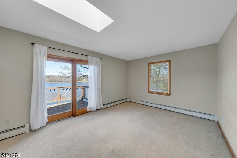 95 Wildwood Road Oak Ridge, NJ 07438 - Photo 19 of 36 a view of an empty room with a window