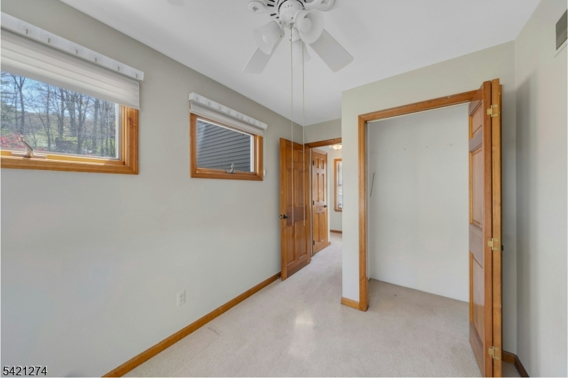 95 Wildwood Road Oak Ridge, NJ 07438 - Photo 21 of 36 a view of an empty room with a window
