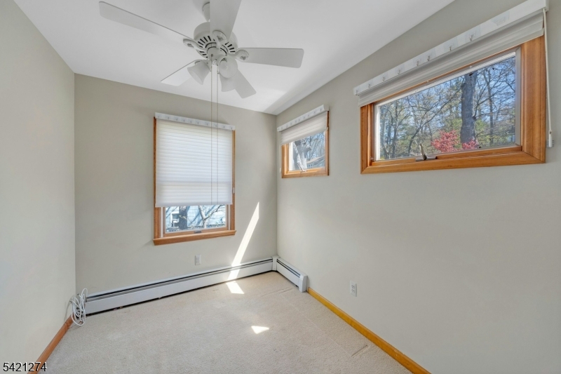 95 Wildwood Road Oak Ridge, NJ 07438 - Photo 22 of 36 a view of an empty room with a window