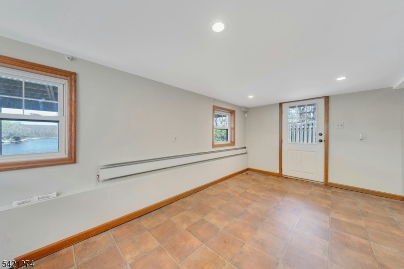 95 Wildwood Road Oak Ridge, NJ 07438 - Photo 27 of 36 a view of an empty room with a window