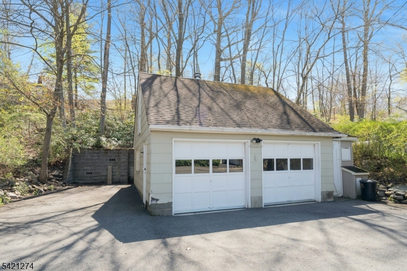 95 Wildwood Road Oak Ridge, NJ 07438 - Photo 28 of 36 a white house that has a tree in front of it