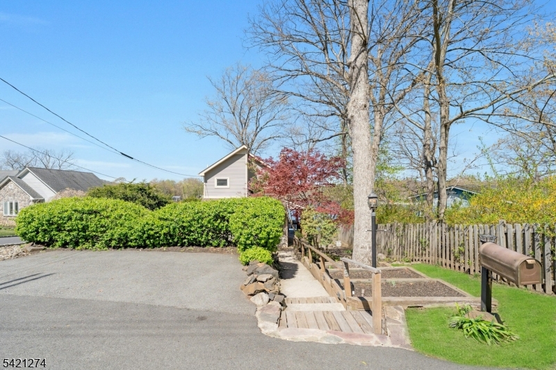 95 Wildwood Road Oak Ridge, NJ 07438 - Photo 29 of 36 a view of a street with potted plants and large trees