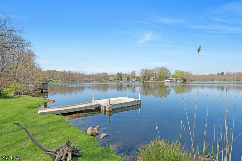 95 Wildwood Road Oak Ridge, NJ 07438 - Photo 31 of 36 a view of a lake with houses in the back