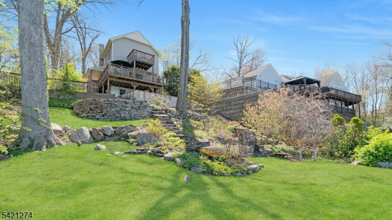 95 Wildwood Road Oak Ridge, NJ 07438 - Photo 32 of 36 a front view of a house with garden