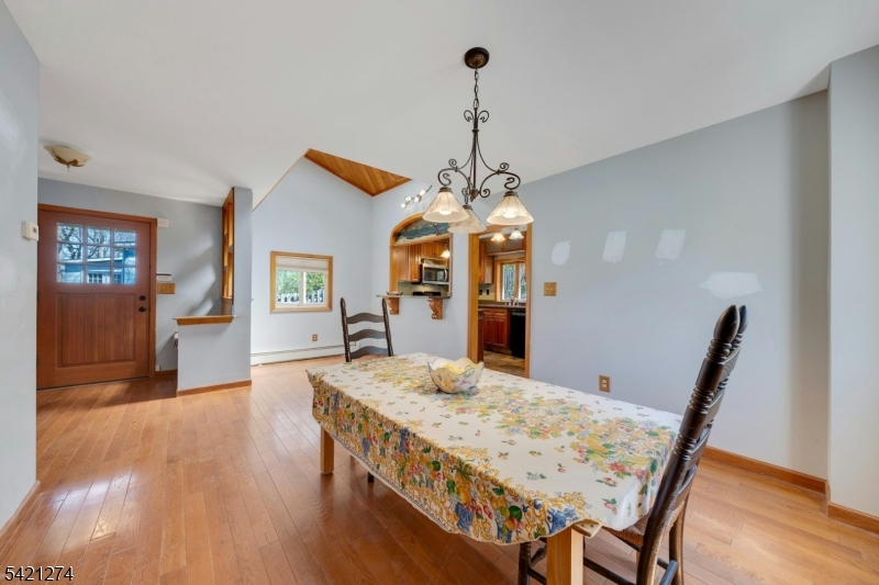 95 Wildwood Road Oak Ridge, NJ 07438 - Photo 7 of 36 a view of a dining room with furniture window and wooden floor