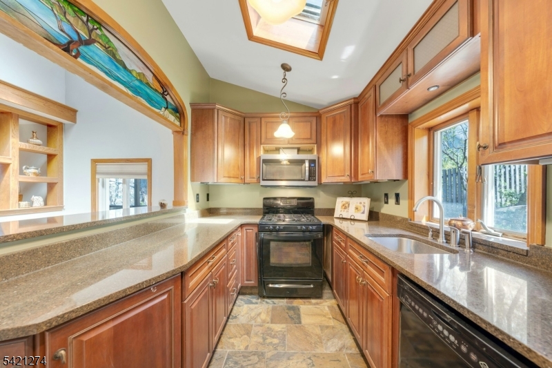 95 Wildwood Road Oak Ridge, NJ 07438 - Photo 10 of 36 a kitchen with a sink stove and cabinets
