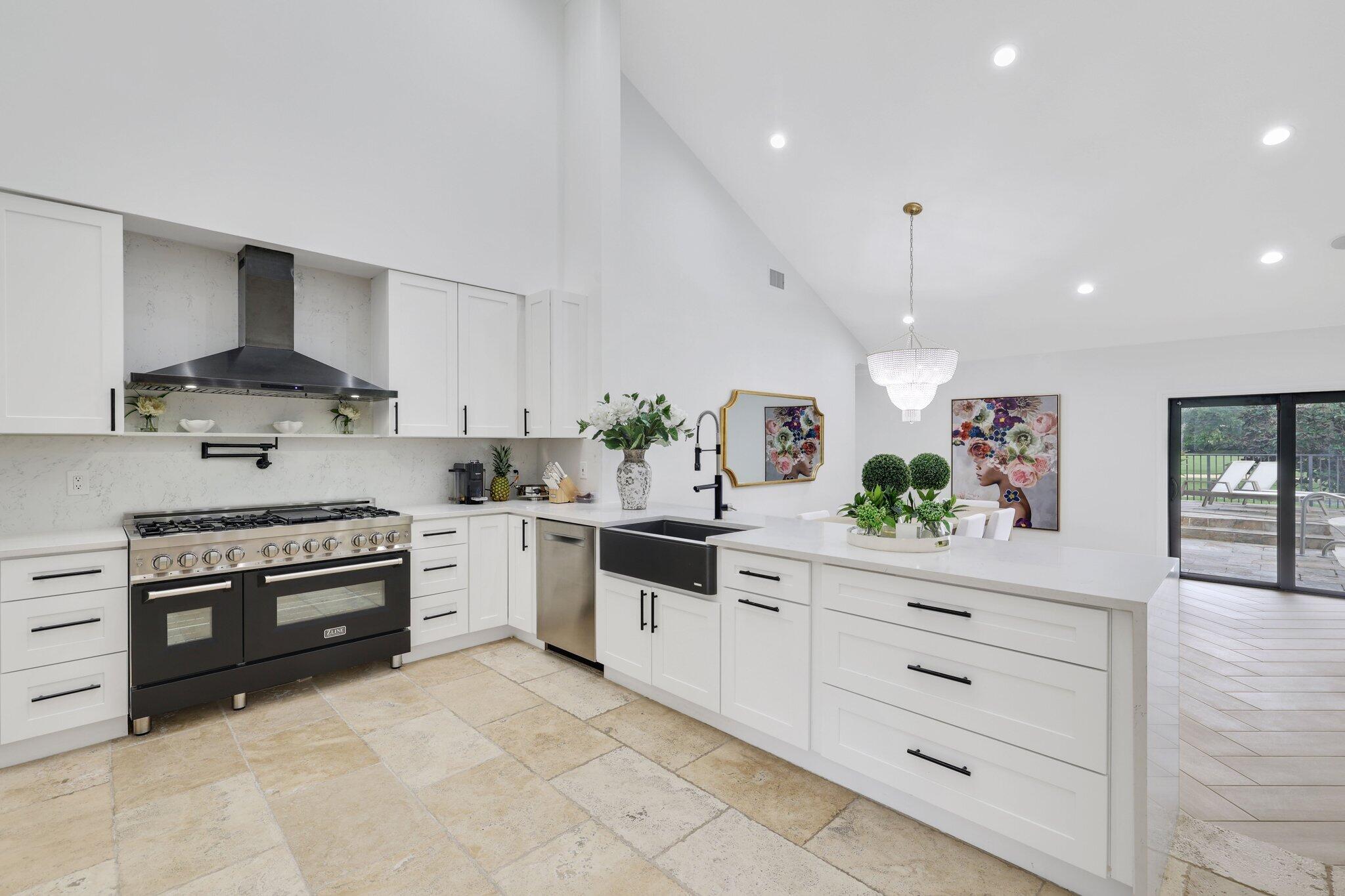 7811 Mandarin Drive Boca Raton, FL 33433 - Photo 10 of 51 a kitchen with white cabinets and appliances