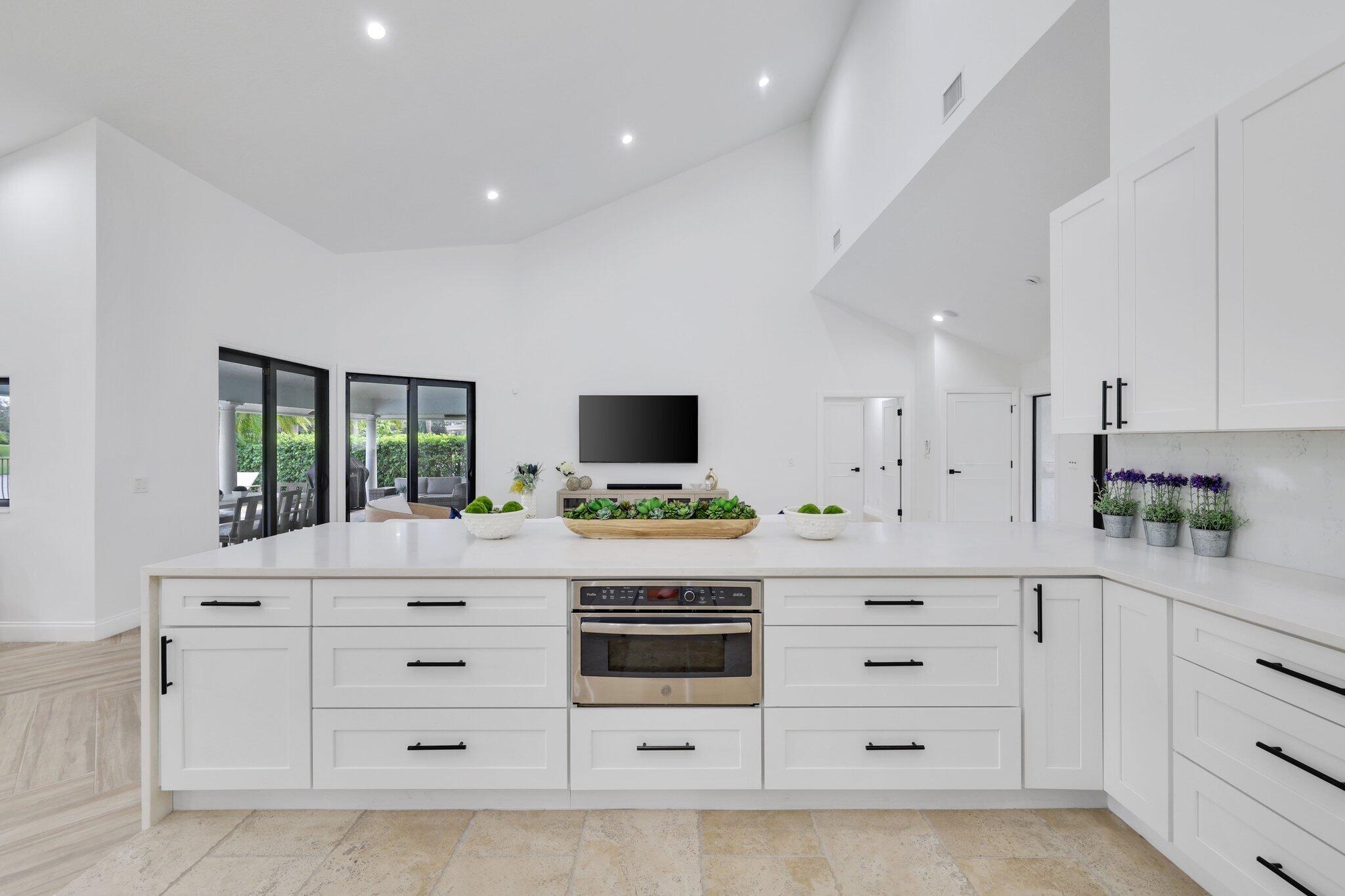7811 Mandarin Drive Boca Raton, FL 33433 - Photo 13 of 51 a kitchen with stainless steel appliances white cabinets and a stove
