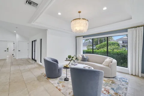 a living room with furniture and a mirror