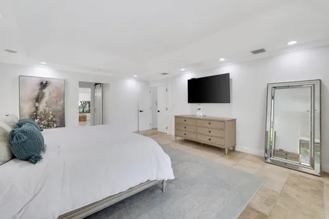 a large bedroom with a bed and glass window