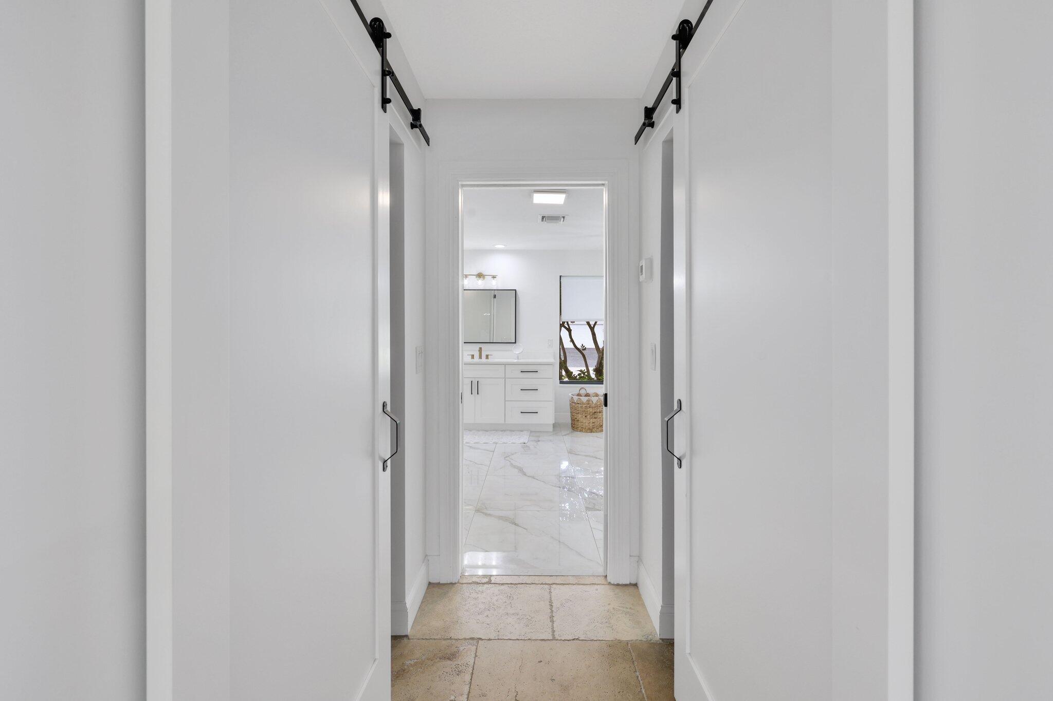7811 Mandarin Drive Boca Raton, FL 33433 - Photo 23 of 51 a view of a bathroom from a hallway