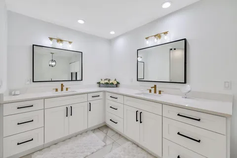 a bathroom with a double vanity sink and mirror