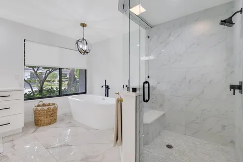 a bathroom with a bathtub and a shower